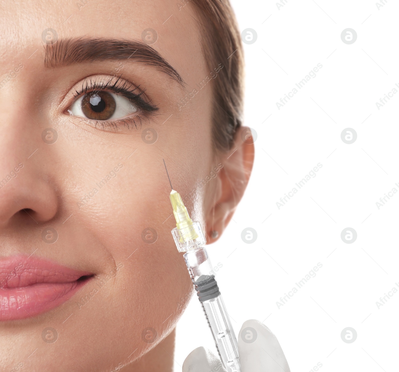 Photo of Beautiful woman getting facial injection on white background, closeup. Cosmetic surgery