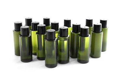 Photo of Mini bottles with cosmetic products on white background