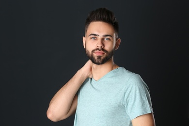 Photo of Portrait of handsome young man on black background