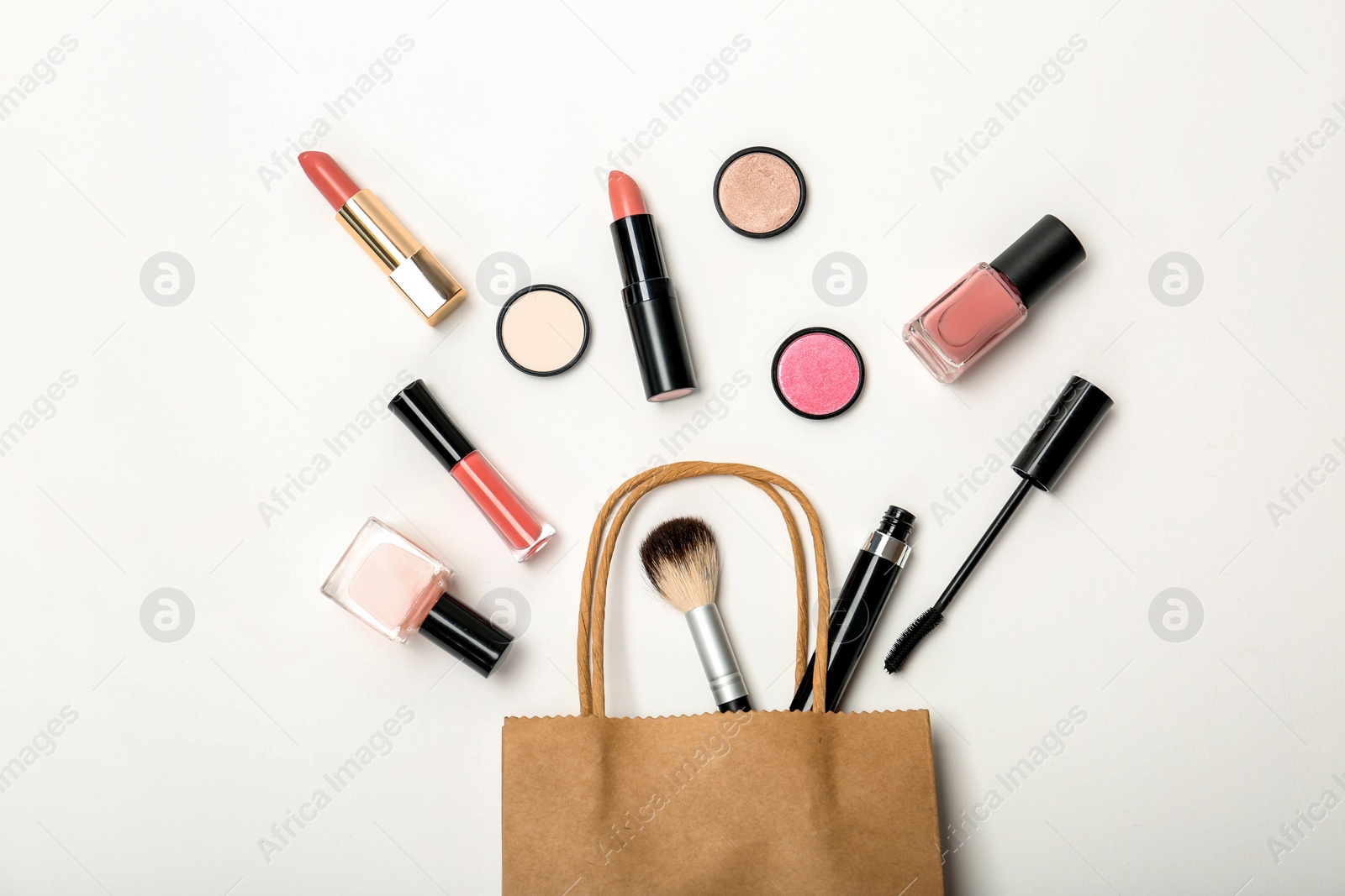 Photo of Flat lay composition with shopping bag and cosmetics on white background