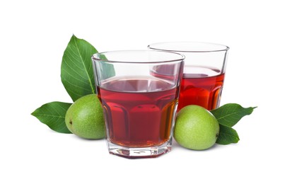 Photo of Delicious liqueur and green walnuts on white background