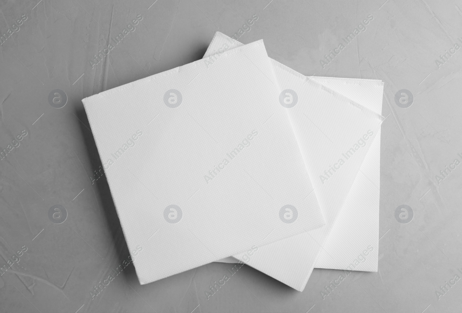 Photo of Clean napkins on light table, top view