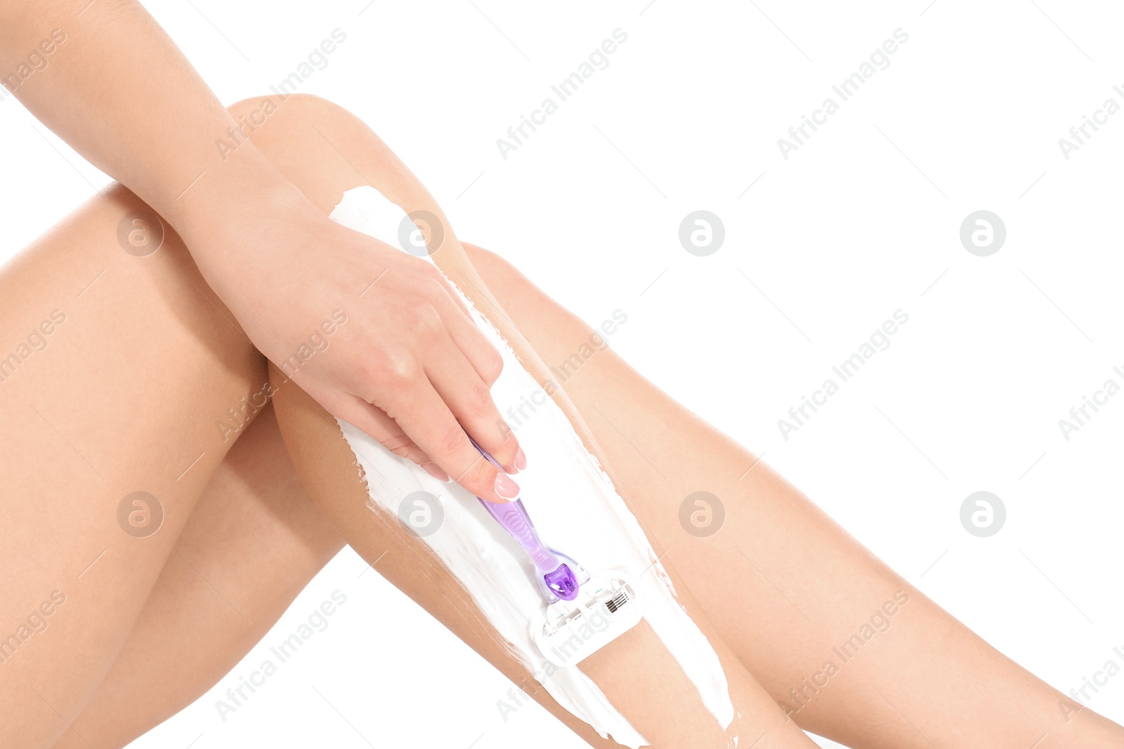 Photo of Beautiful young woman shaving leg on white background, closeup view