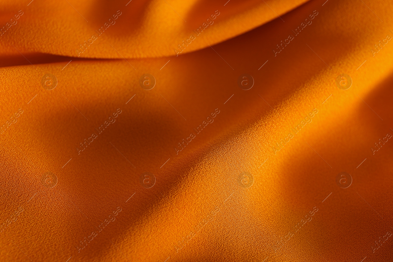 Photo of Texture of orange crumpled fabric as background, closeup view