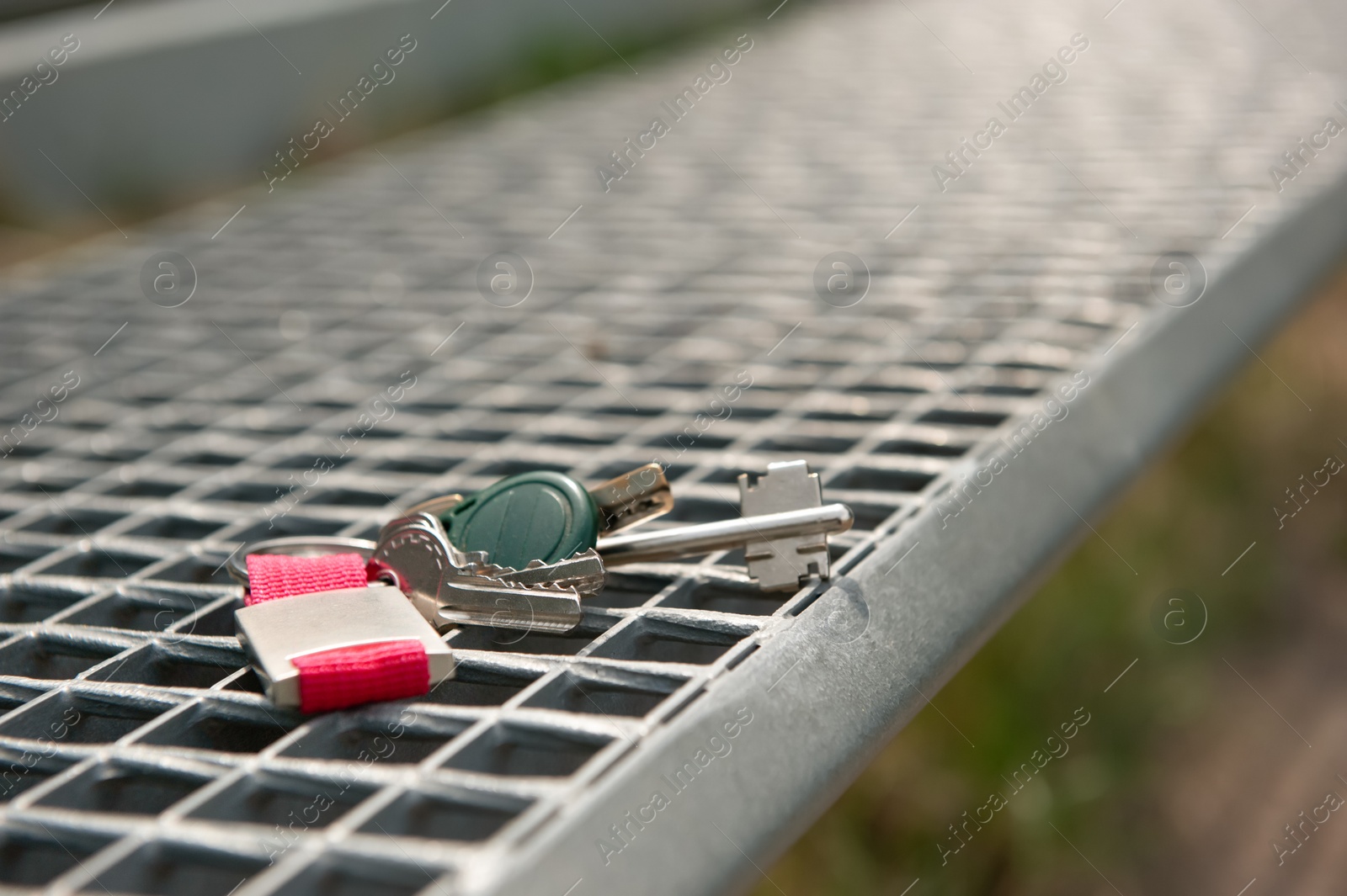 Photo of Keys forgotten on metal bench outdoors. Lost and found