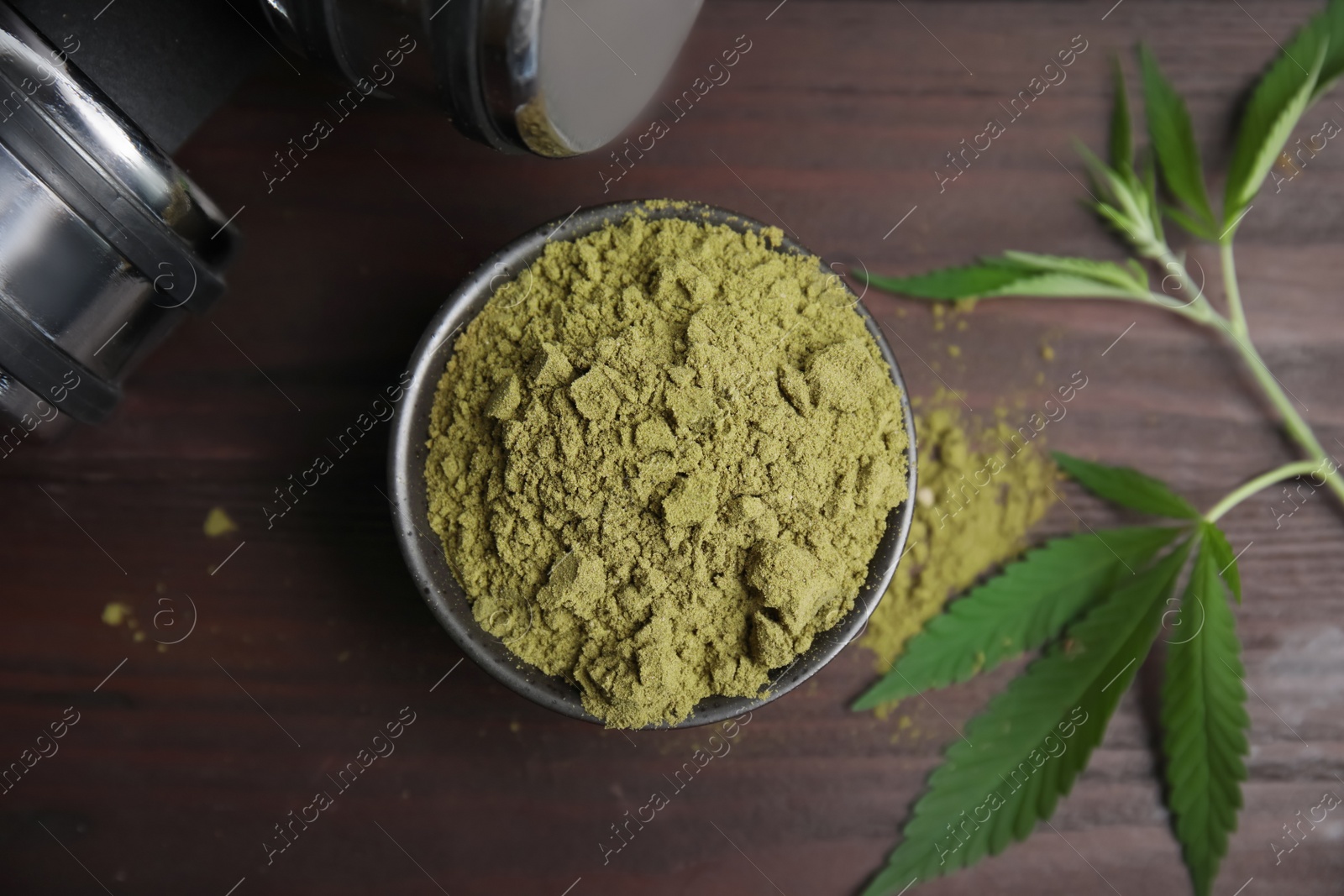 Photo of Hemp protein powder, fresh leaves and dumbbells on wooden table, flat lay