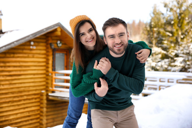 Lovely couple spending time together on snowy day. Winter vacation