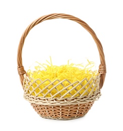 Photo of Wicker basket with yellow filler isolated on white. Easter item
