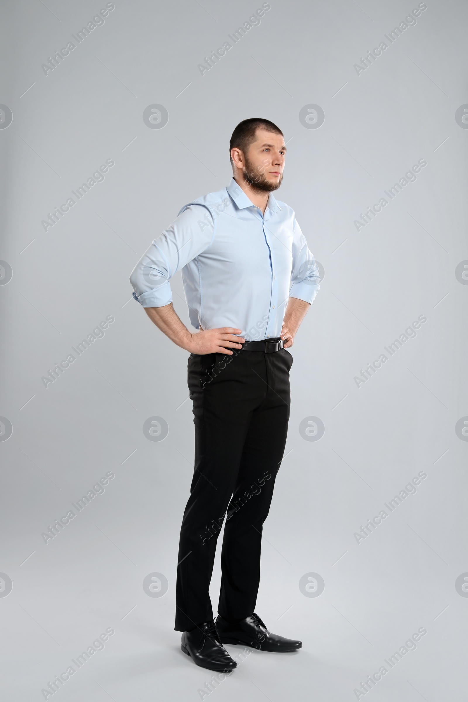 Photo of Full length portrait of thoughtful businessman on grey background