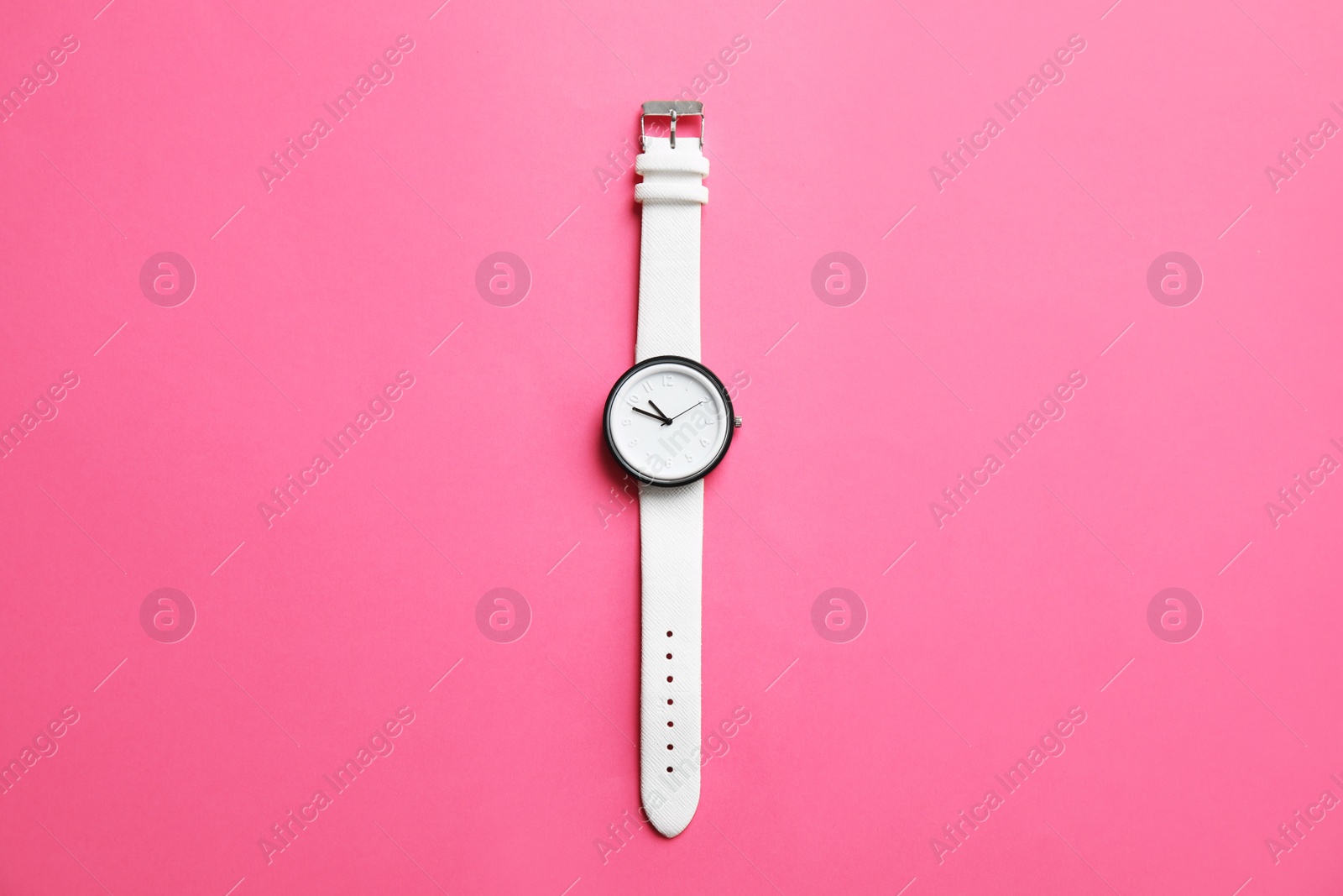 Photo of Stylish wrist watch on color background, top view. Fashion accessory