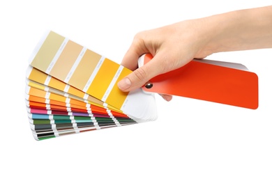 Woman holding color palette samples on white background