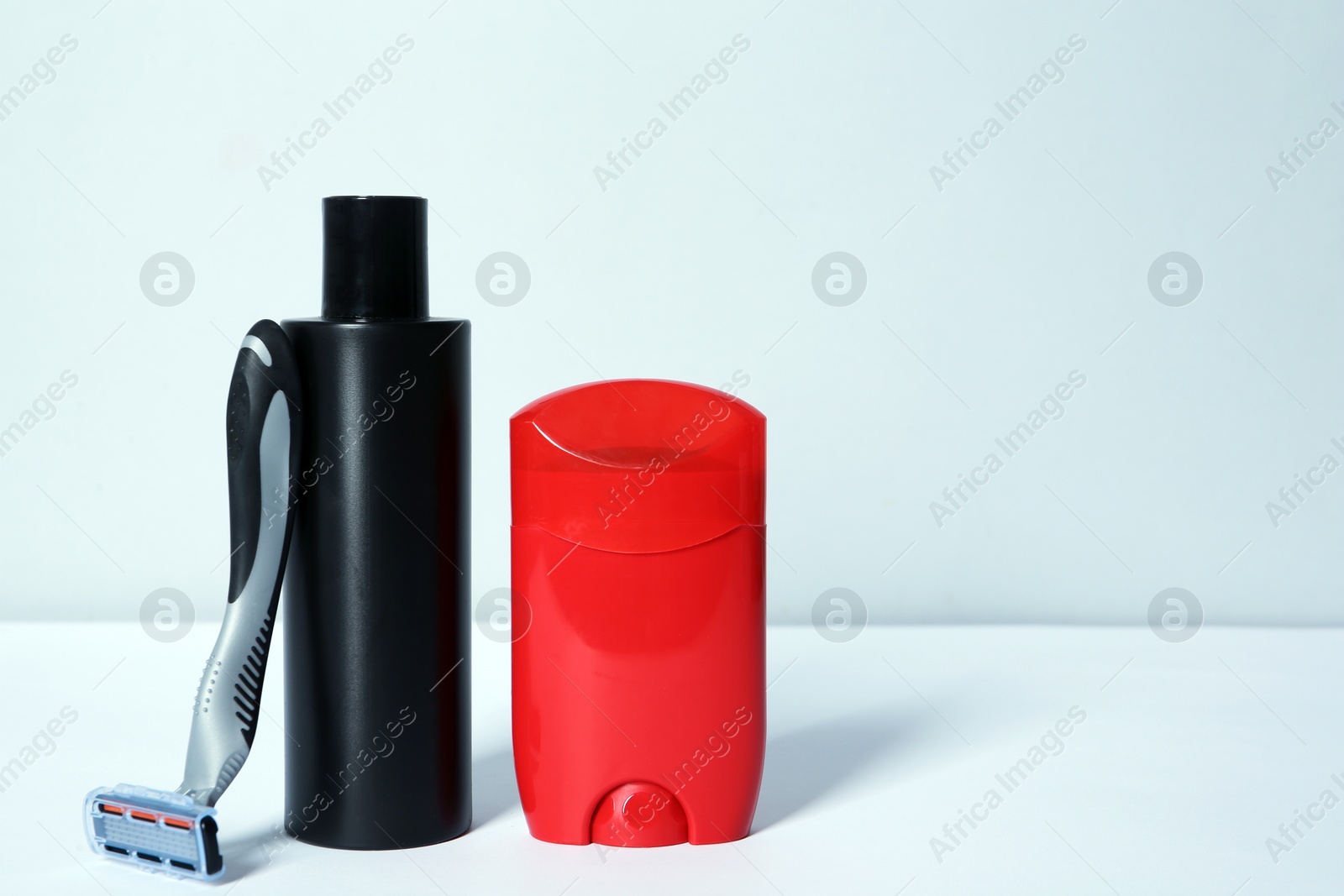 Photo of Razor, shaving lotion and deodorant for men on white background. Space for text