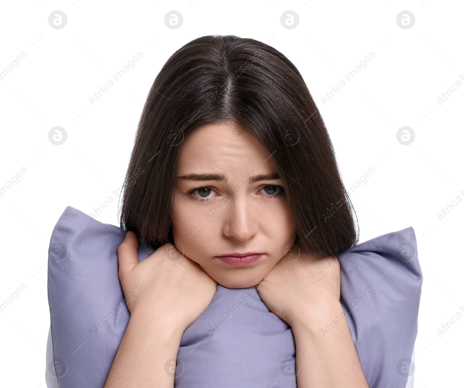 Photo of Unhappy young woman with pillow on white background. Insomnia problem