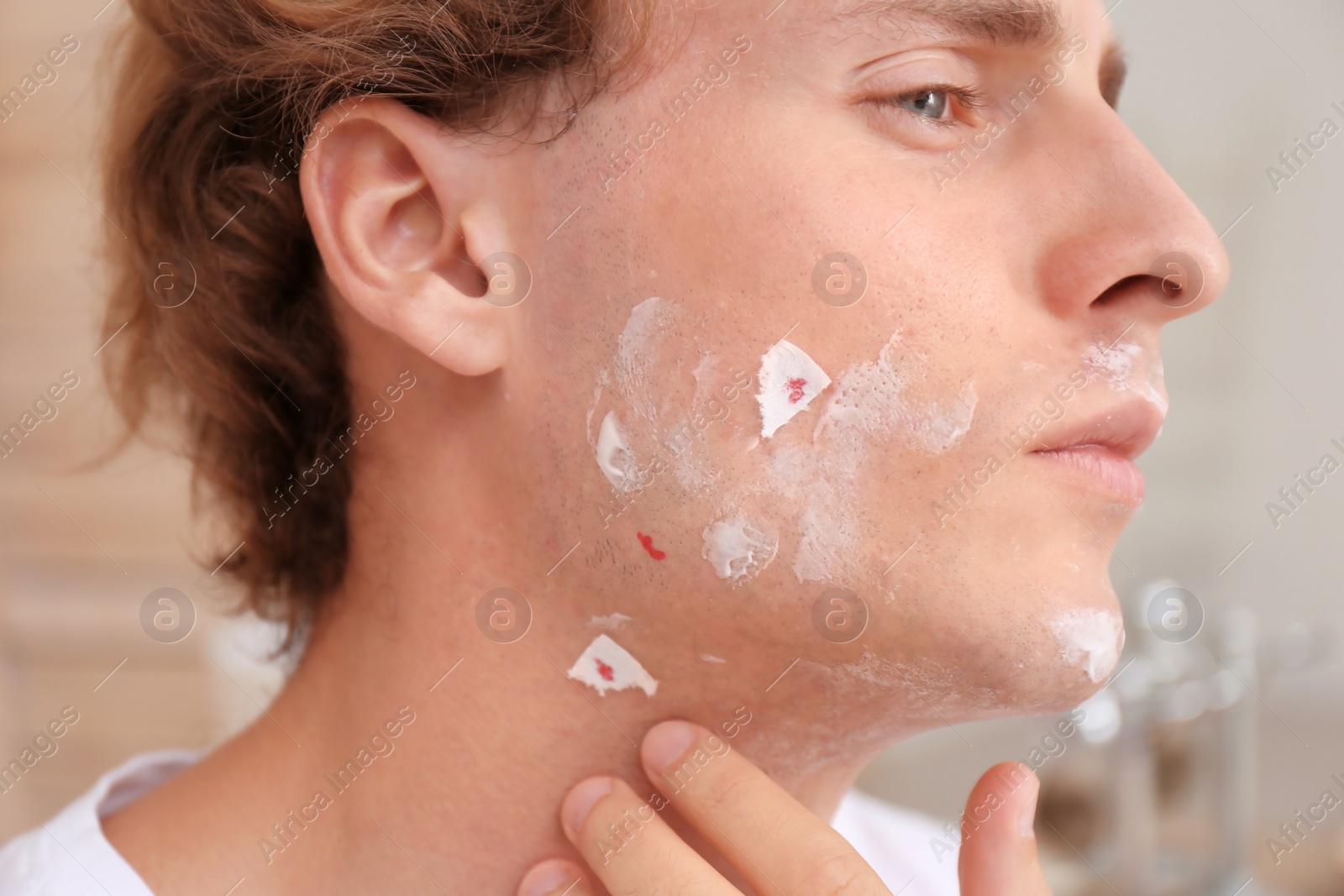 Photo of Young man with face hurt while shaving at home