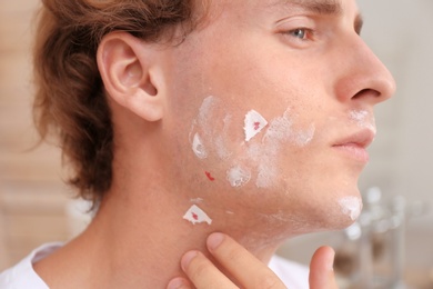 Photo of Young man with face hurt while shaving at home