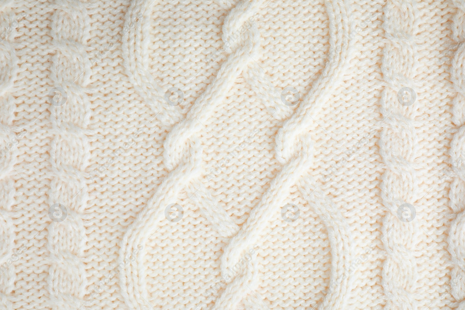 Photo of White knitted sweater as background, closeup view