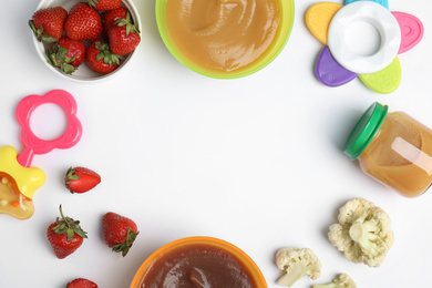 Photo of Frame of baby food, ingredients and toys on white background, flat lay. Space for text