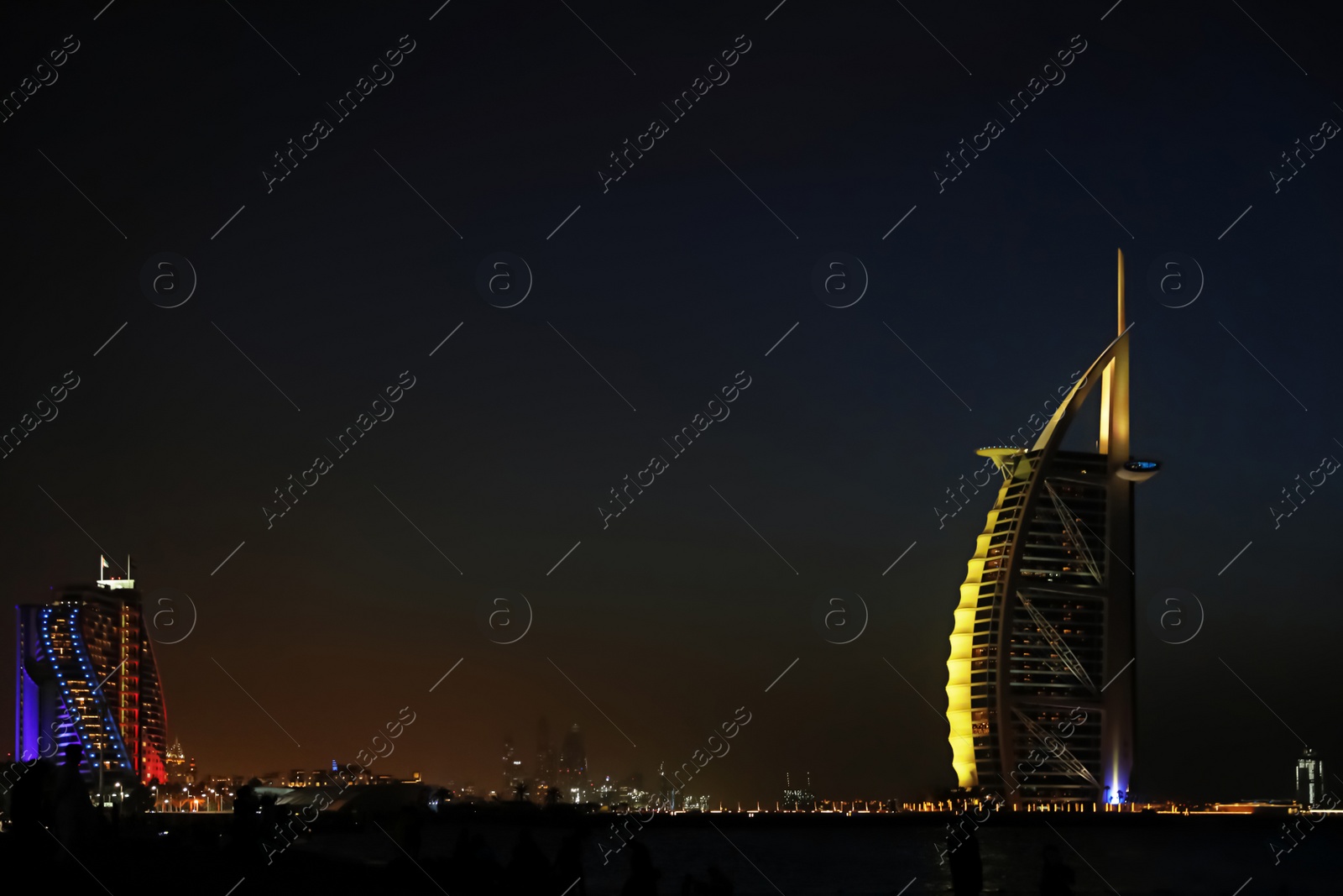 Photo of DUBAI, UNITED ARAB EMIRATES - NOVEMBER 03, 2018: Night landscape with illuminated Burj Al Arab