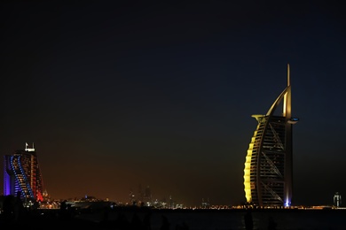 Photo of DUBAI, UNITED ARAB EMIRATES - NOVEMBER 03, 2018: Night landscape with illuminated Burj Al Arab