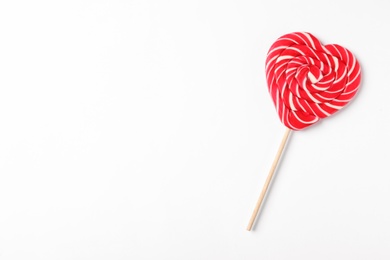 Sweet heart shaped lollipop on white background, top view with space for text. Valentine's day celebration