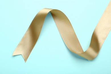 Photo of Beautiful ribbon on light blue background, top view