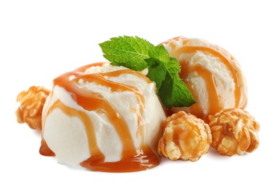 Photo of Scoops of delicious ice cream with caramel sauce, mint and popcorn on white background