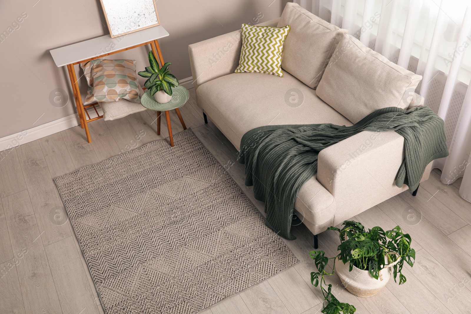 Photo of Living room interior with stylish rug and furniture, above view