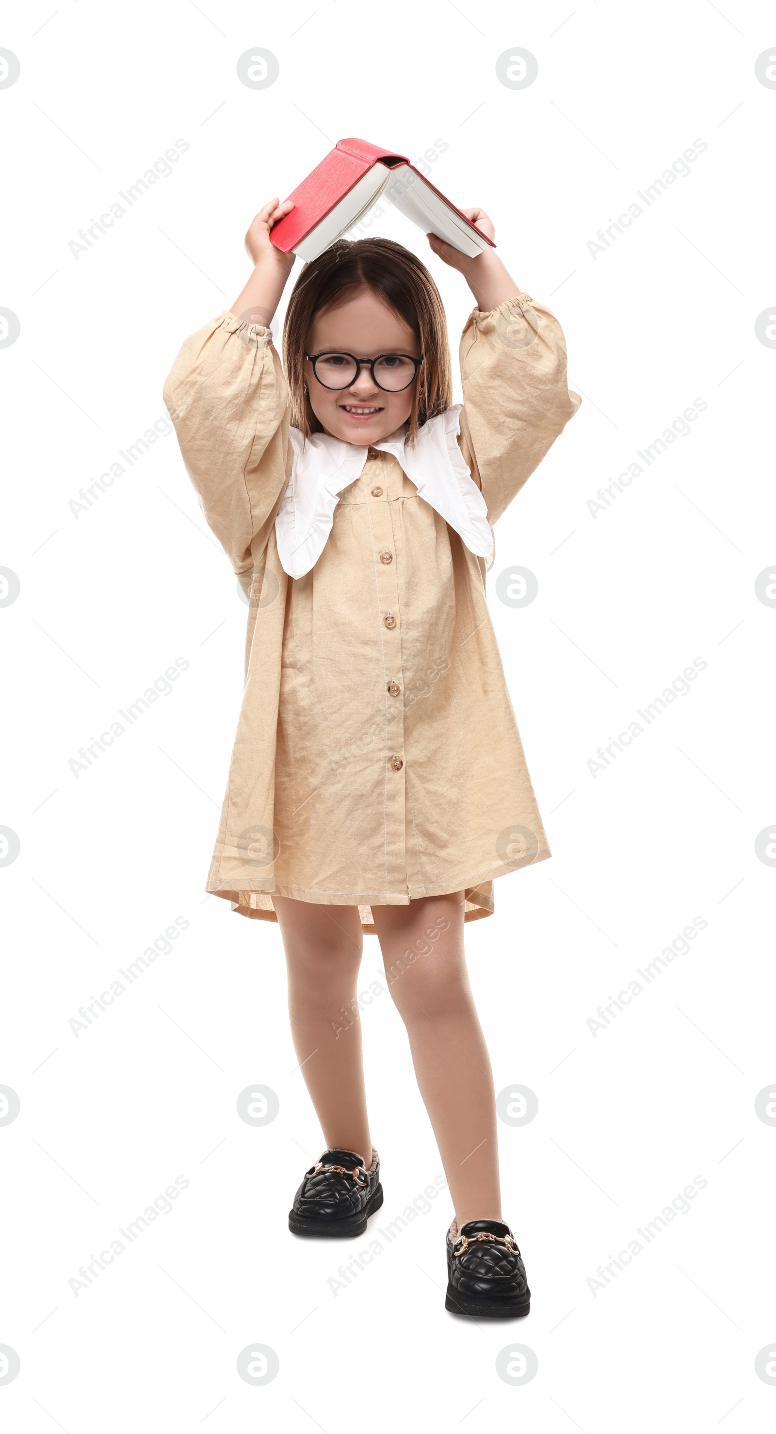 Photo of Cute little girl in glasses with open book on white background