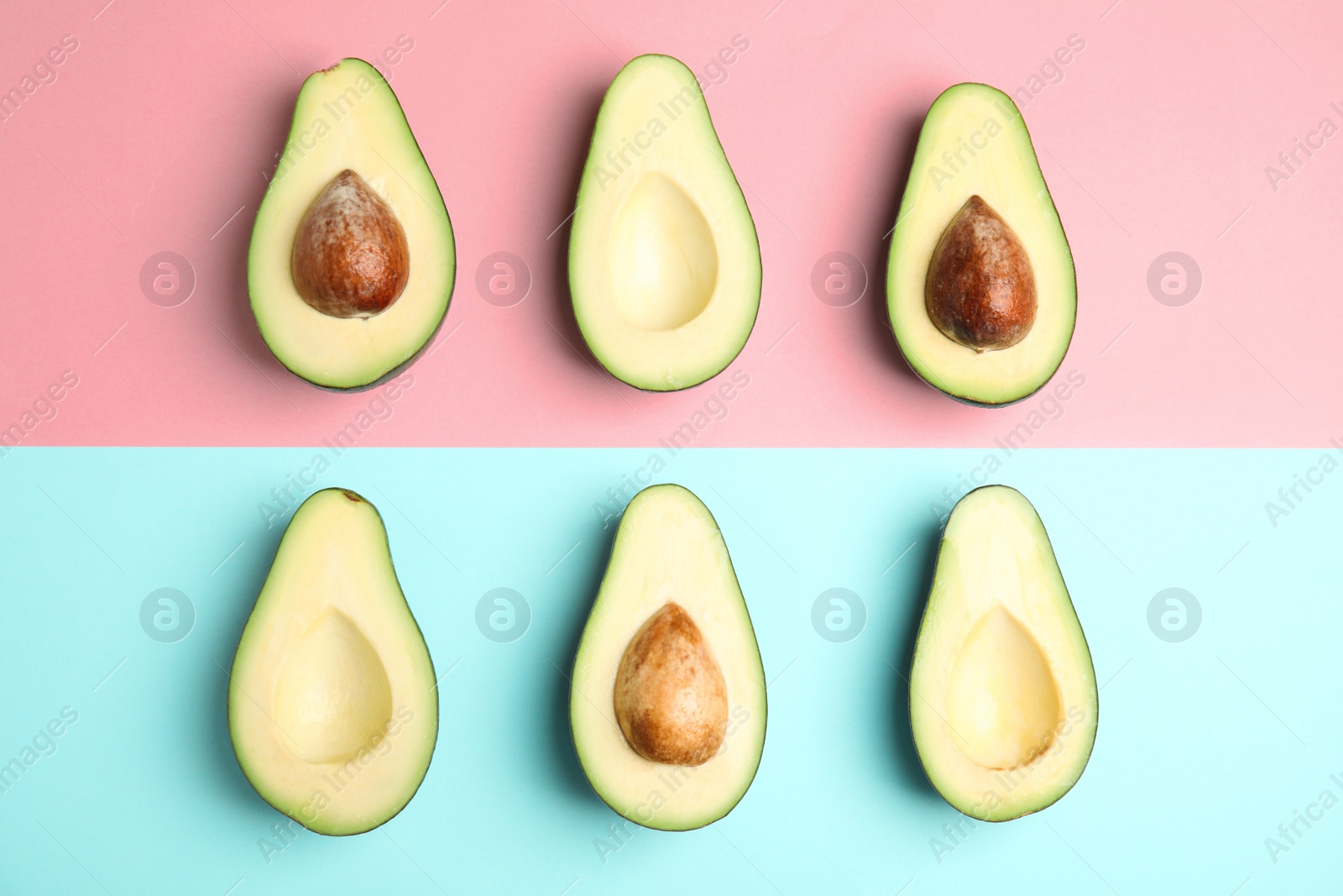 Photo of Cut fresh ripe avocados on color background, flat lay