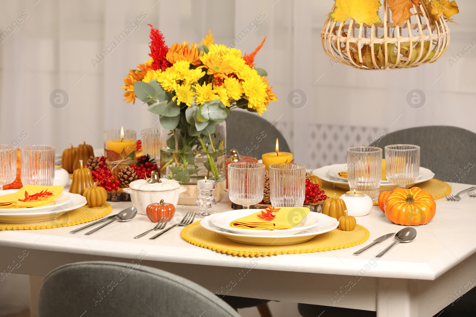 Photo of Autumn table setting with floral decor and pumpkins indoors