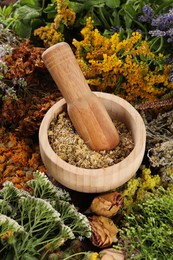 Photo of Mortar with pestle and many different herbs