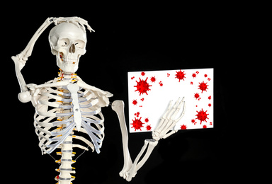 Artificial human skeleton with illustration of virus on black background