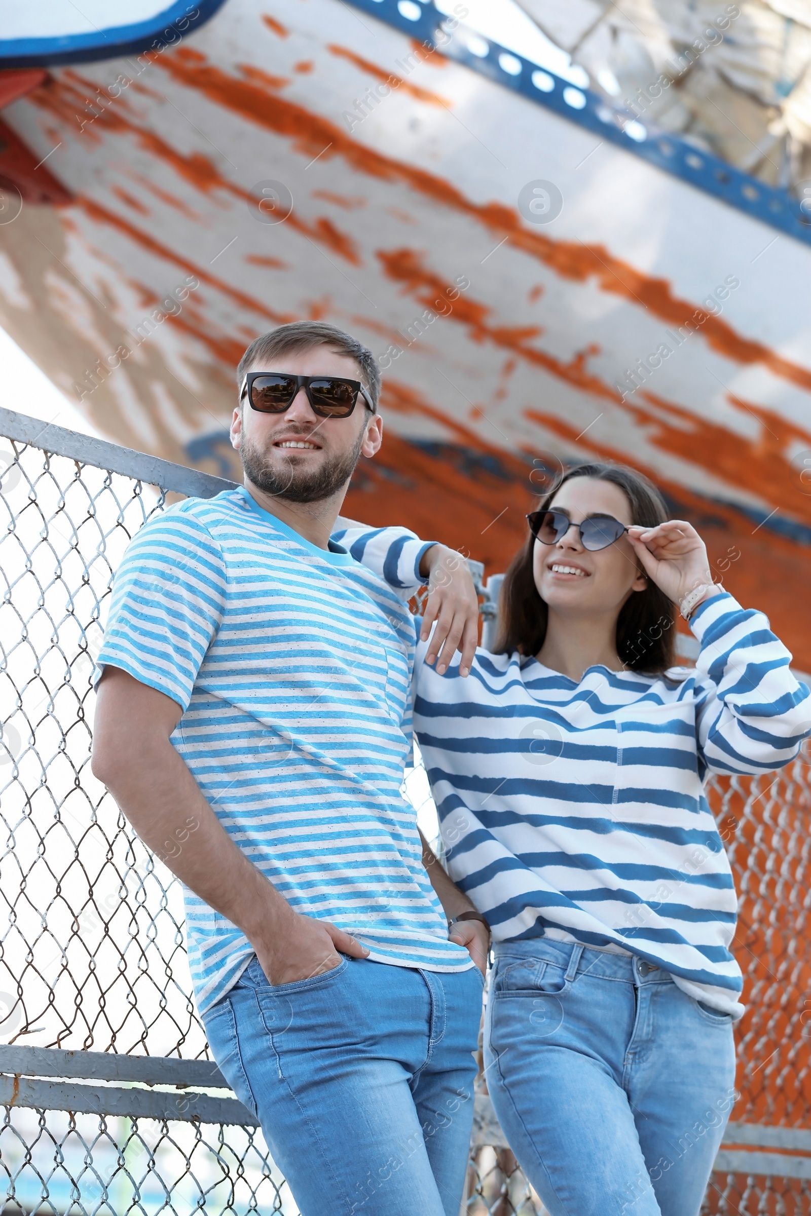 Photo of Young hipster couple in stylish jeans on pier