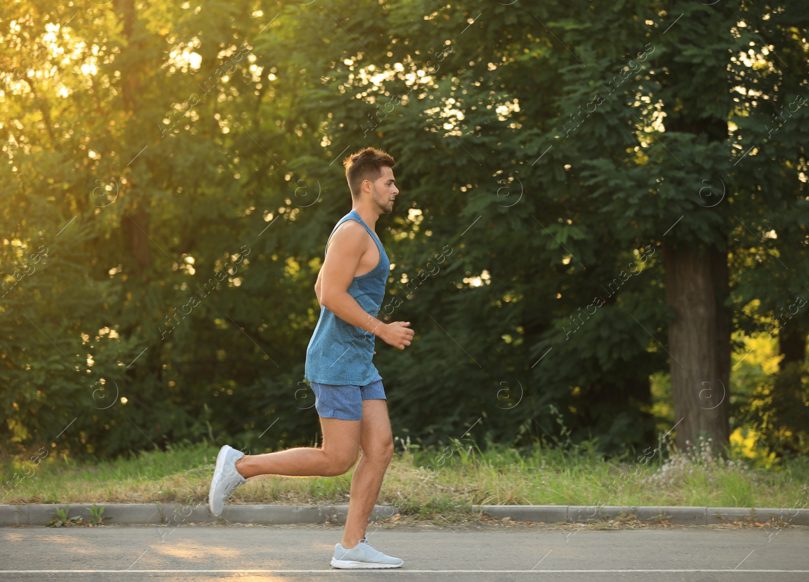 Photo of Young man running in park on sunny day