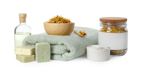 Photo of Spa composition. Towel, essential oil, soap and dry flowers on white background