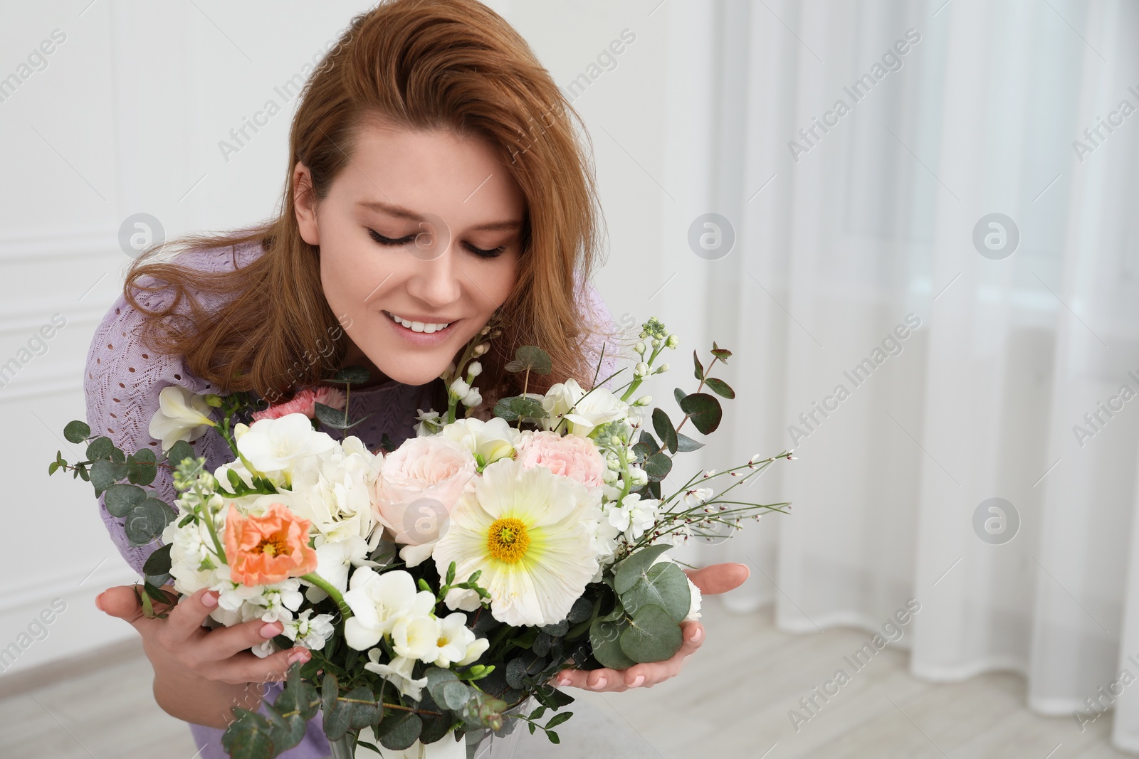 Photo of Beautiful woman with bouquet of flowers indoors. Space for text