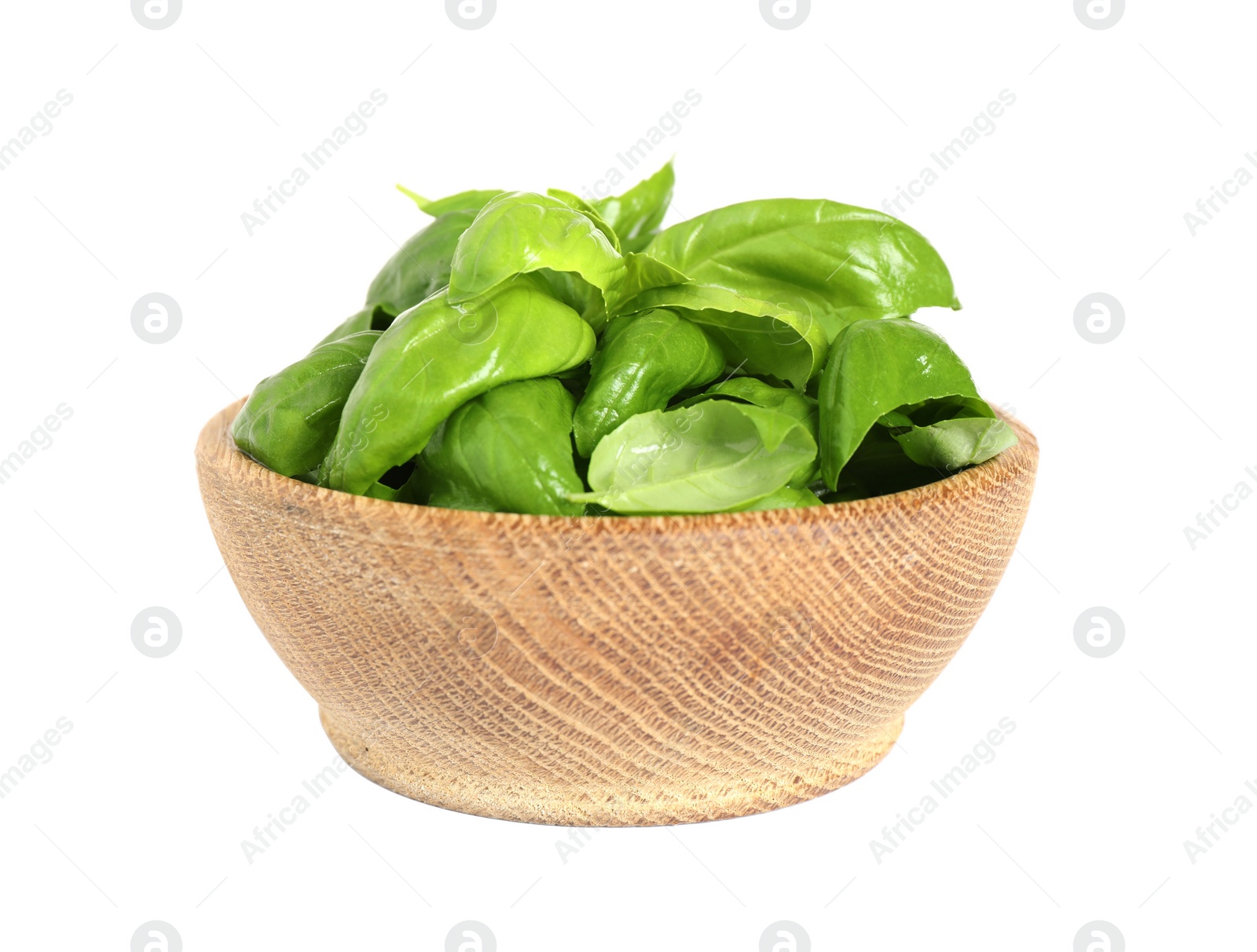 Photo of Fresh green basil leaves in wooden bowl isolated on white