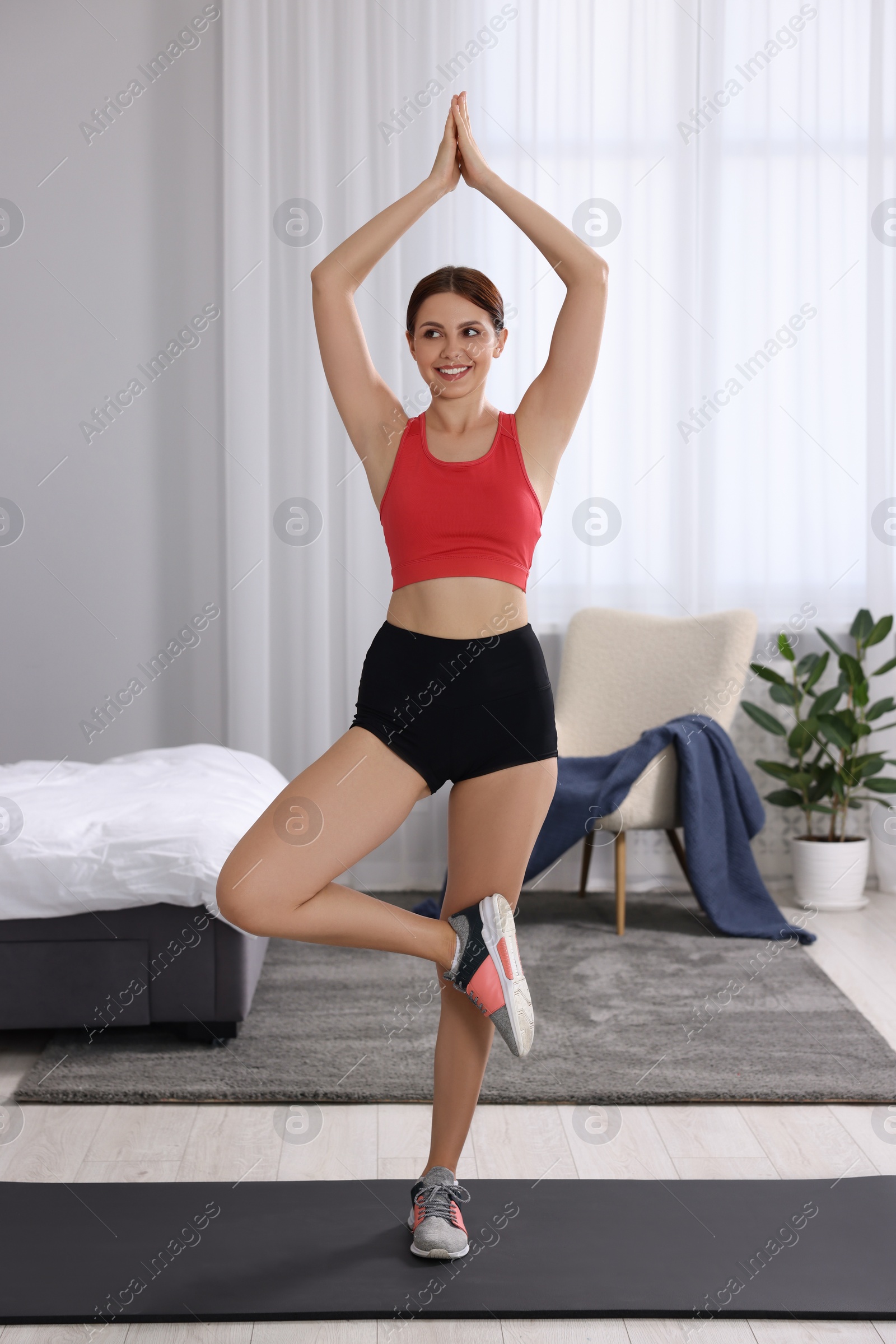 Photo of Happy woman doing morning exercise at home