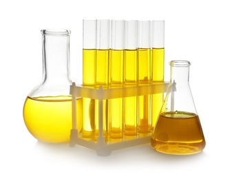 Photo of Laboratory glassware with yellow liquid on white background