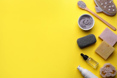 Flat lay composition with pumice stone on yellow background. Space for text
