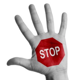 Image of Woman showing palm with drawn STOP sign on white background, closeup