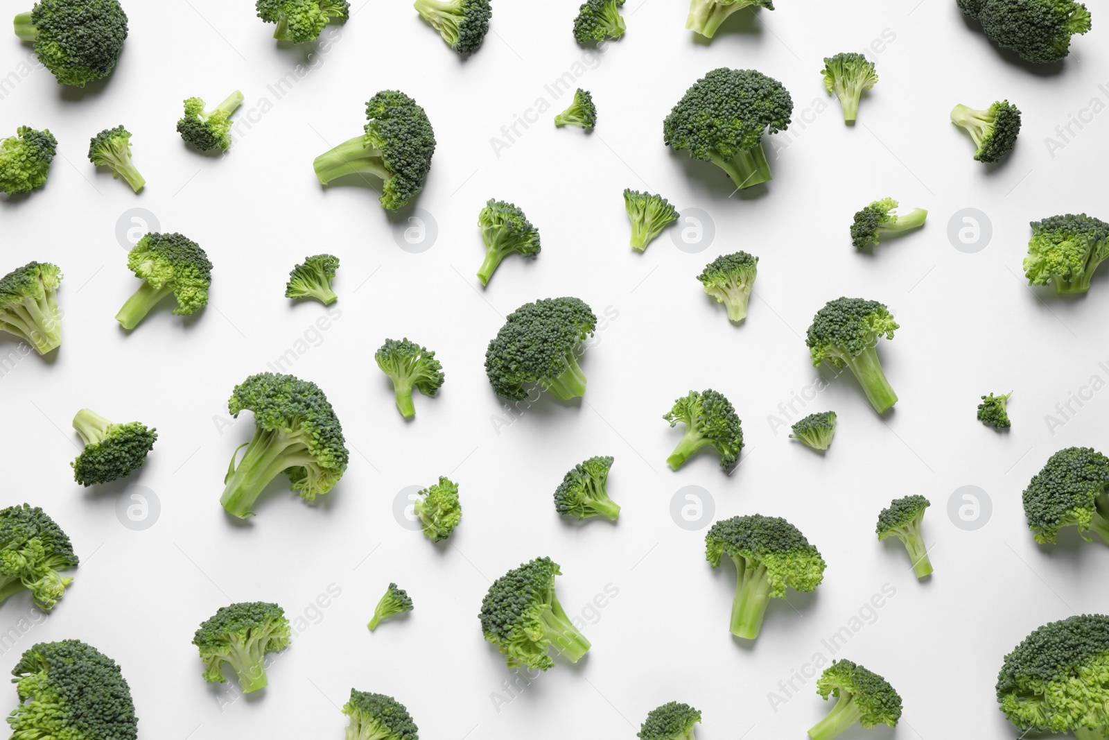 Photo of Fresh tasty broccoli on white background, top view