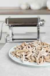 Photo of Uncooked homemade soba (buckwheat noodles) on grey table in kitchen