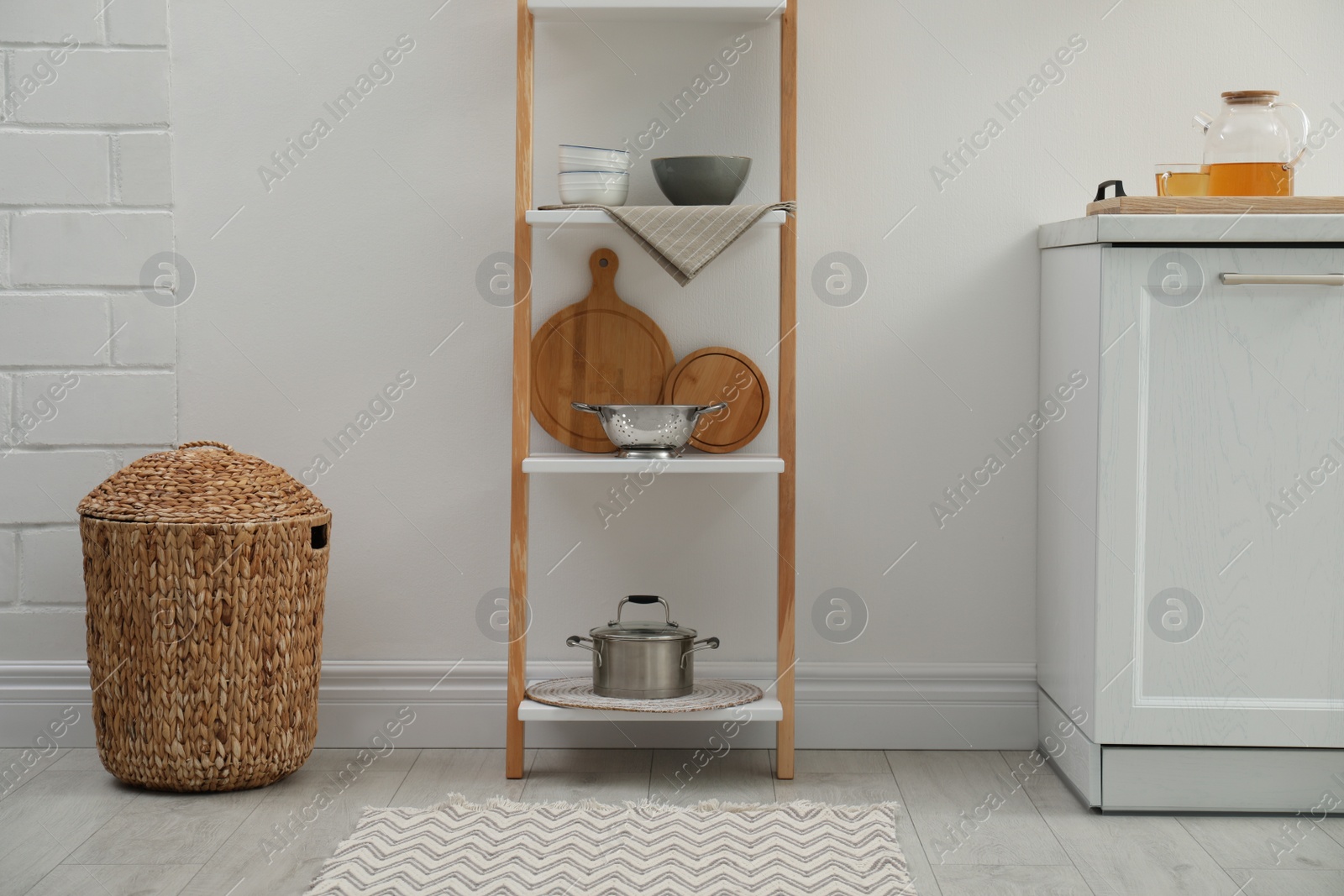 Photo of Stylish kitchen room interior with wooden ladder near white wall