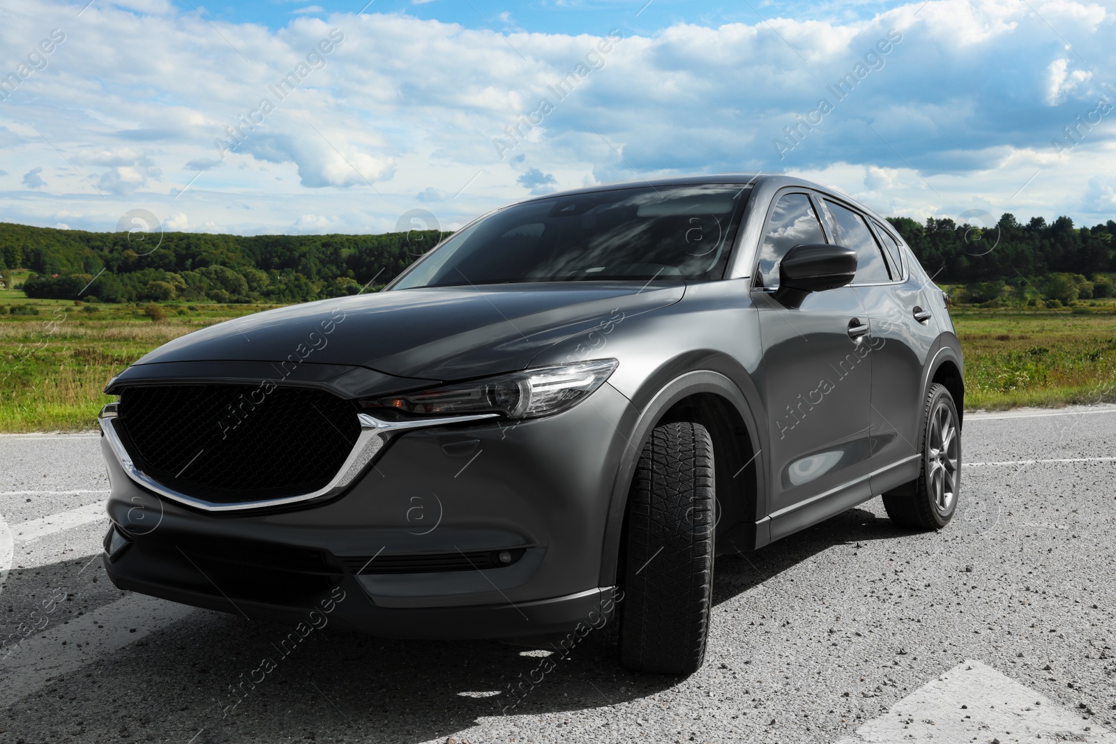 Photo of New black modern car parked outdoors, low angle view