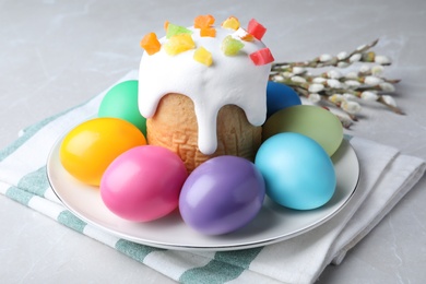 Beautiful Easter cake and painted eggs on light grey marble table