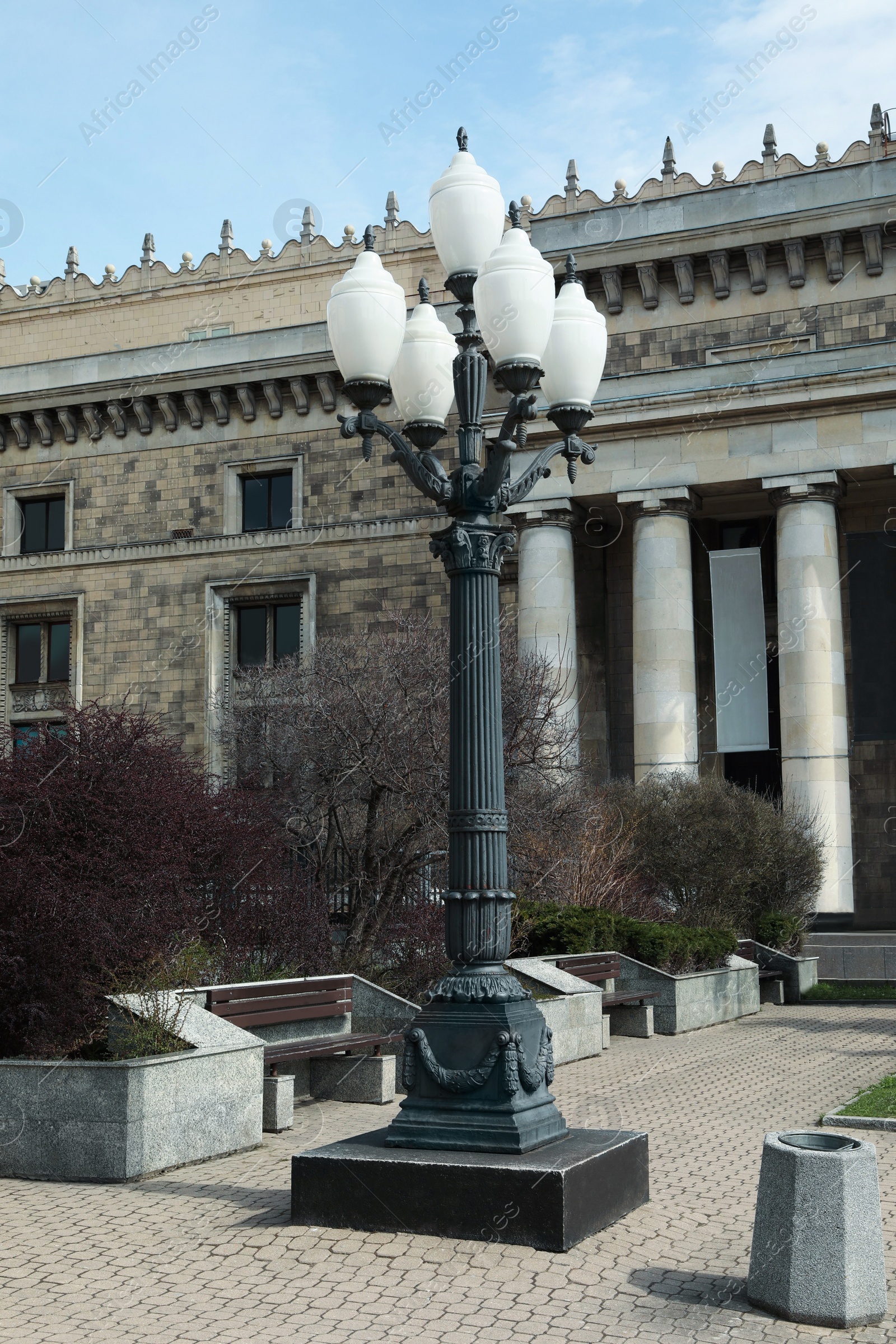 Photo of Old fashioned street light lamp near building in city