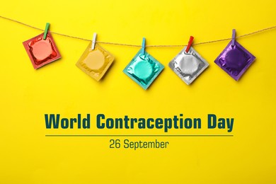 Image of World contraception day. Colorful condoms hanging on clothesline on yellow background