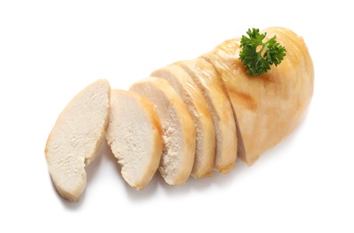 Partially cut fried chicken breast with parsley on white background