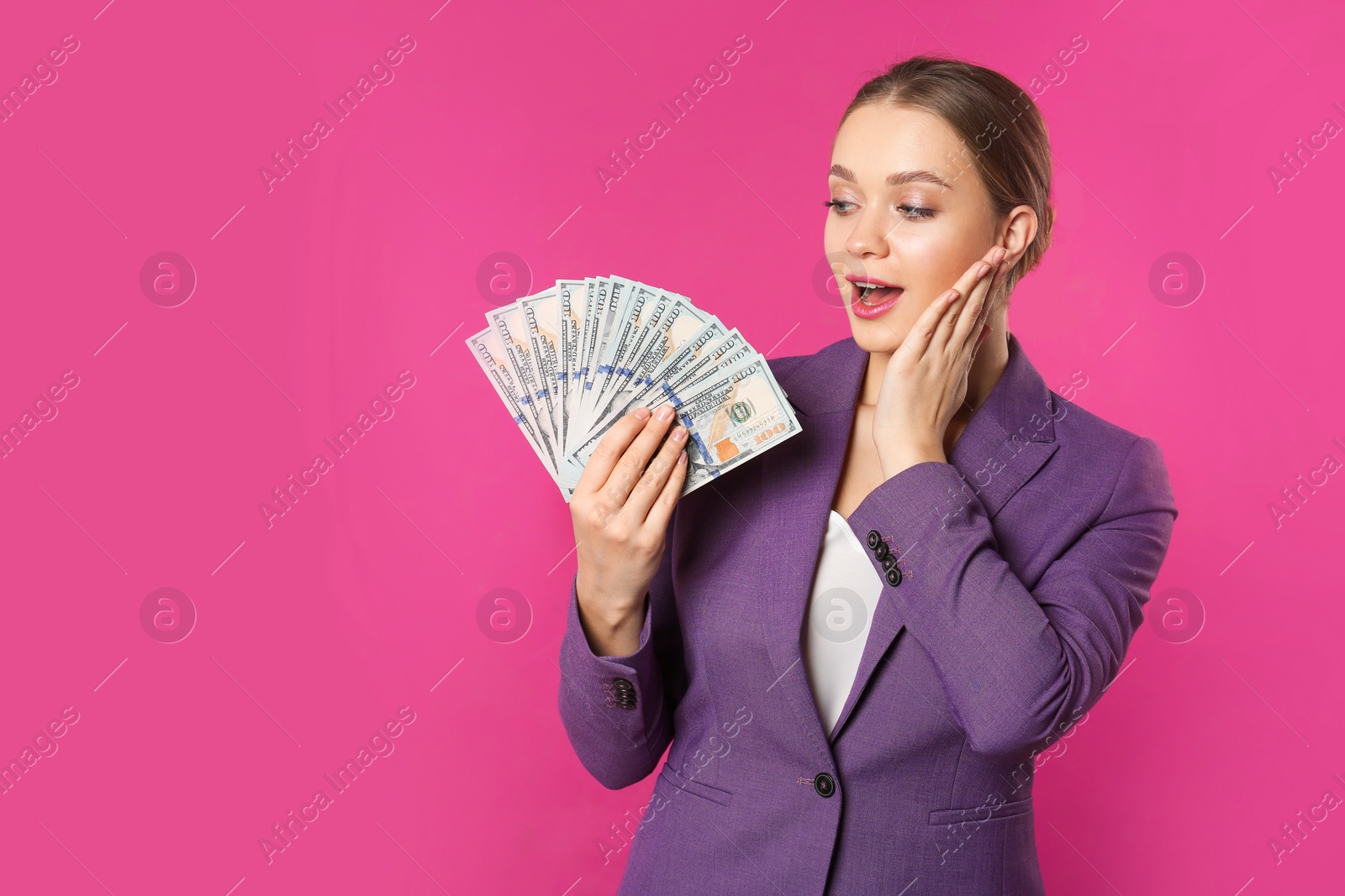 Photo of Portrait of emotional young businesswoman with money on color background. Space for text